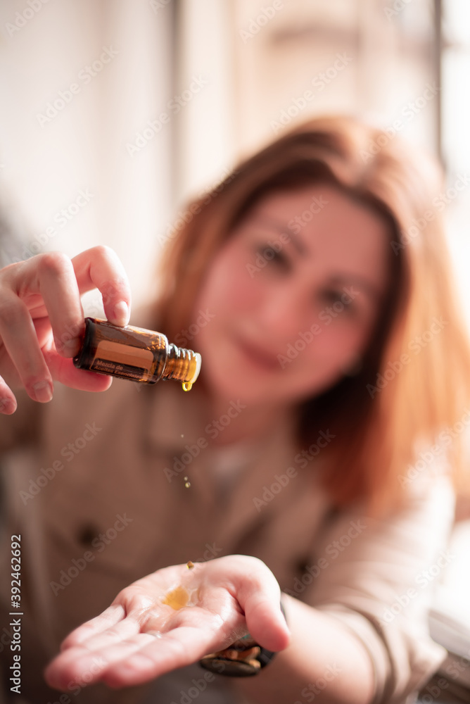 Fototapeta premium Woman with essence of oils, doTERRA essential oils to make pure, potent,High quality essential oils.
