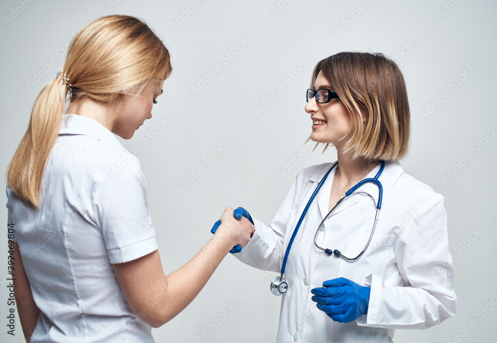 Nurse and patient gestures with hands light background stethoscope disease Nurse and patient gestures with hands light background stethoscope disease