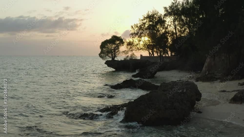 Aerial shot Zanzibar Tanzania. Drone video of an island in the Indian Ocean at sunrise / sunset. beautiful landscape video with yellow sky, coastline, rocks and trees.
Aerial shot Zanzibar Tanzania. Drone video of an island in the Indian Ocean at sunrise / sunset. beautiful landscape video with yellow sky, coastline, rocks and trees.