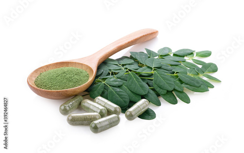 Dried moringa leaves and fresh on white background photo