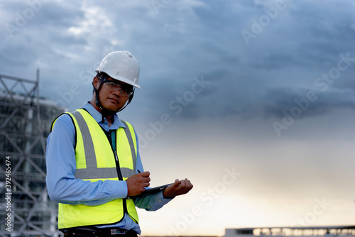 Engineering Consulting on construction site holding tablet in his hand with copy space. Management in business workflow and Building inspector with BIM technology in Construction Project. © kokliang1981