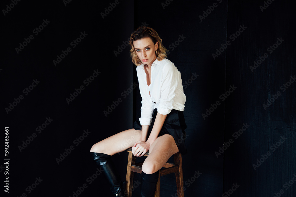 Beautiful fashionable woman blonde clothes white shirt black portrait shorts Beautiful fashionable woman blonde clothes white shirt black portrait shorts
