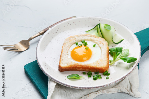 Fried egg on bread with vegetables