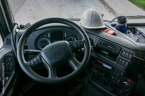 Personal protective equipment in the cabin of a truck that transports dangerous goods, consisting of a helmet, protective glasses, gas mask and an explosimeter.