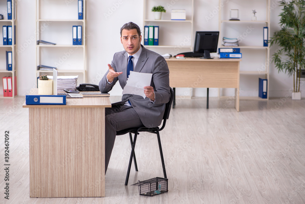 Young male employee and mousetrap in the office Young male employee and mousetrap in the office