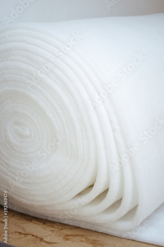 Vertical of a roll of white padding for furniture