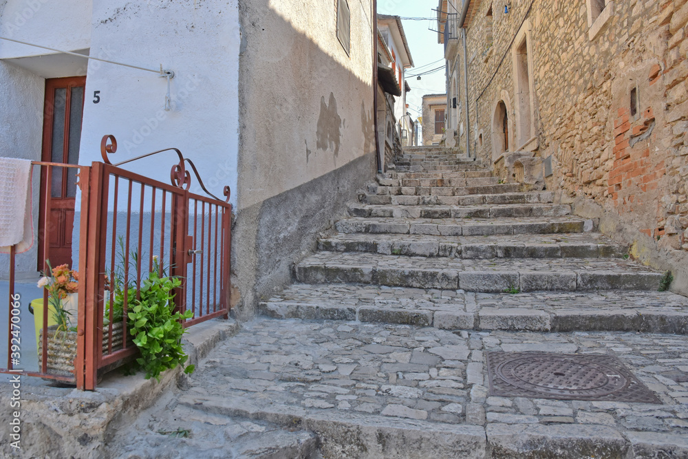 A narrow street among the old houses of Pietrelcina, a medieval village in the Campania region, Italy.