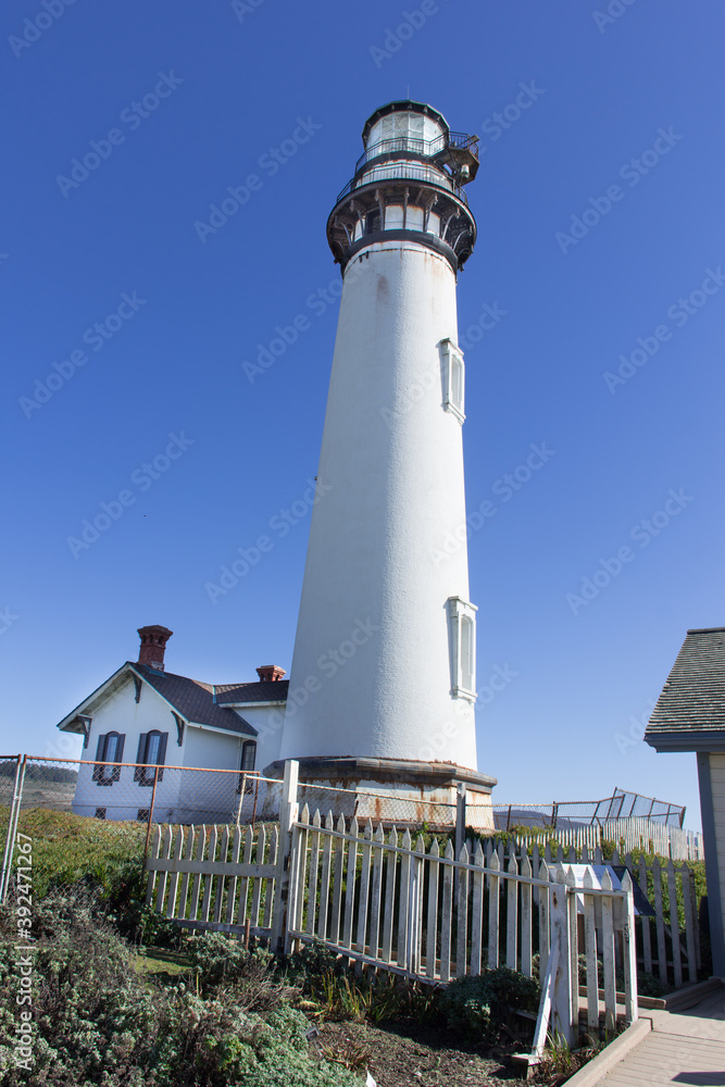 Pigeon Point Lighthouse and keeper's quarters on the California coast on a bright, clear, sunny day