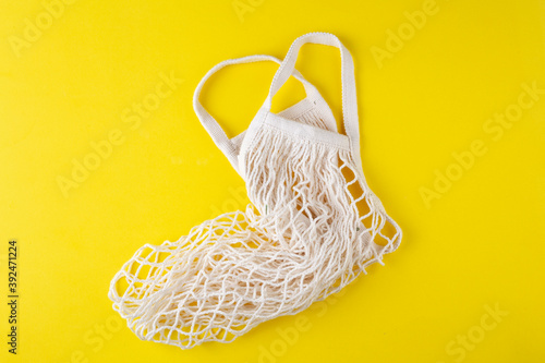 empty string bag on a yellow background, top view, eco bag