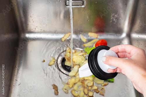 vegetable waste in the kitchen sink, garbage shredder photo