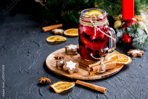 Christmas hot mulled wine with cinnamon cardamom and anise. Dark vintage dirty background. Creative atmospheric decoration