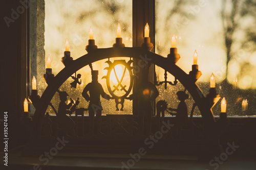 candle arch with miners in window