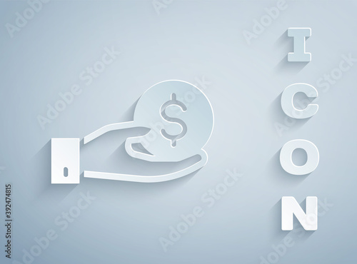 Paper cut Human hand giving money icon isolated on grey background. Receiving money icon. Paper art style. Vector.