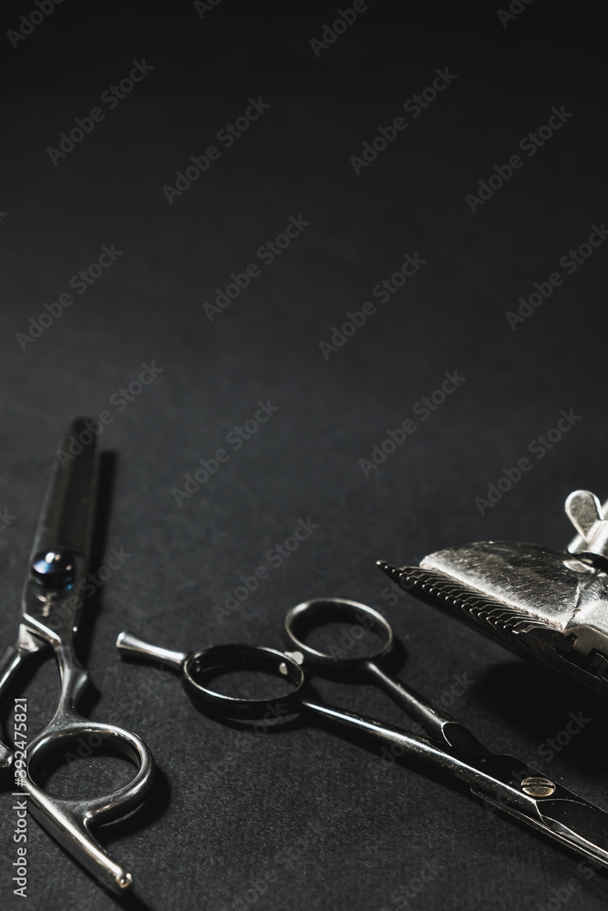 On a black surface are old barber tools. black monochrome. Barbershop background. contrast shadows. Vertical. On a black surface are old barber tools. black monochrome. Barbershop background. contrast shadows. Vertical.