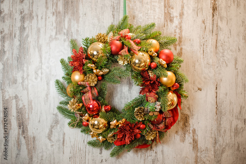 beautiful christmas wreath made of artificial fir branches with christmas tree toys