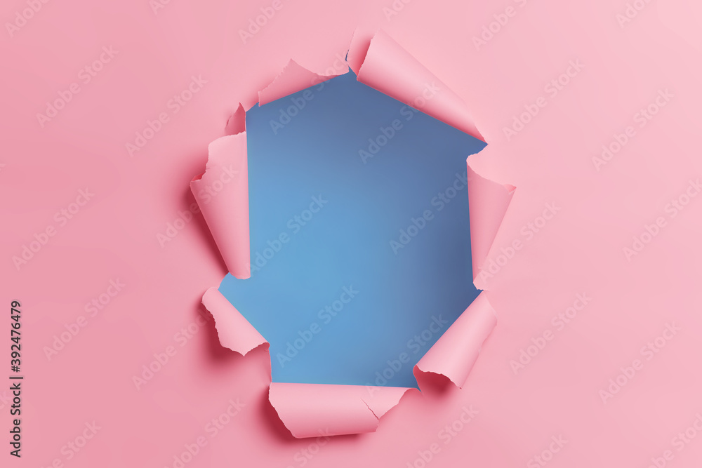 Torn ripped pink background with hole in center for your advertising content or promotion. Blank space to insert object. Absract horizontal shot. Breakthrough concept. Nobody at image. Through paper - obrazy, fototapety, plakaty 