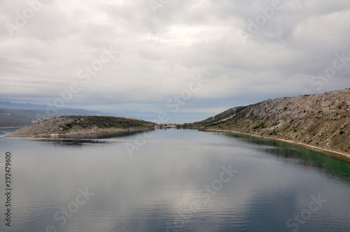 Island Krk - Croatian shoreline, islands and clouds in the sunny day. Typical rocky coast of Croatia by the Adriatic Sea