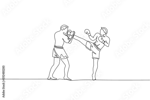 One single line drawing of young energetic man kickboxer practice with personal trainer in boxing arena graphic vector illustration. Healthy lifestyle sport concept. Modern continuous line draw design