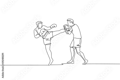 One continuous line drawing of young sporty man kickboxer athlete training with personal trainer who hold punch bag at gym center. Combative sport concept. Single line draw design vector illustration