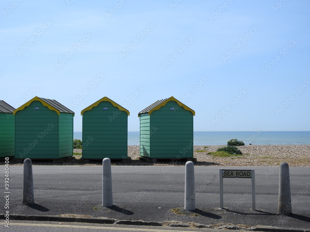Naklejka premium Sea road sign, street, coastal colorful sheds and sea