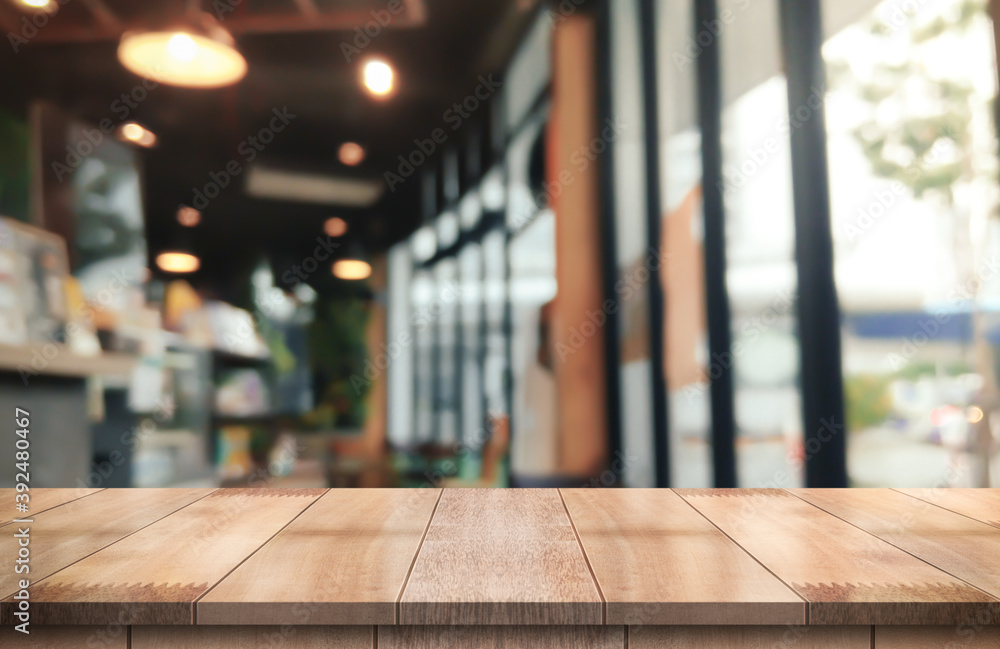 Empty wooden table top with lights bokeh on blur restaurant background. Empty wooden table top with lights bokeh on blur restaurant background.