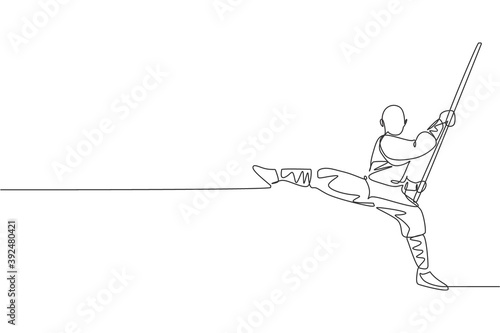 One single line drawing of young energetic shaolin monk man exercise kung fu fighting with stick at temple vector illustration. Chinese martial art sport concept. Modern continuous line draw design