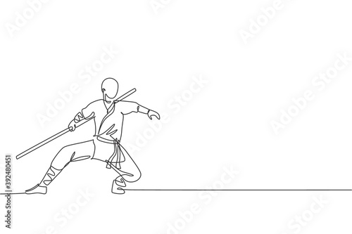 One continuous line drawing of young shaolin monk man practice kung fu with stick at temple ground. Traditional Chinese combative sport concept. Dynamic single line draw design vector illustration