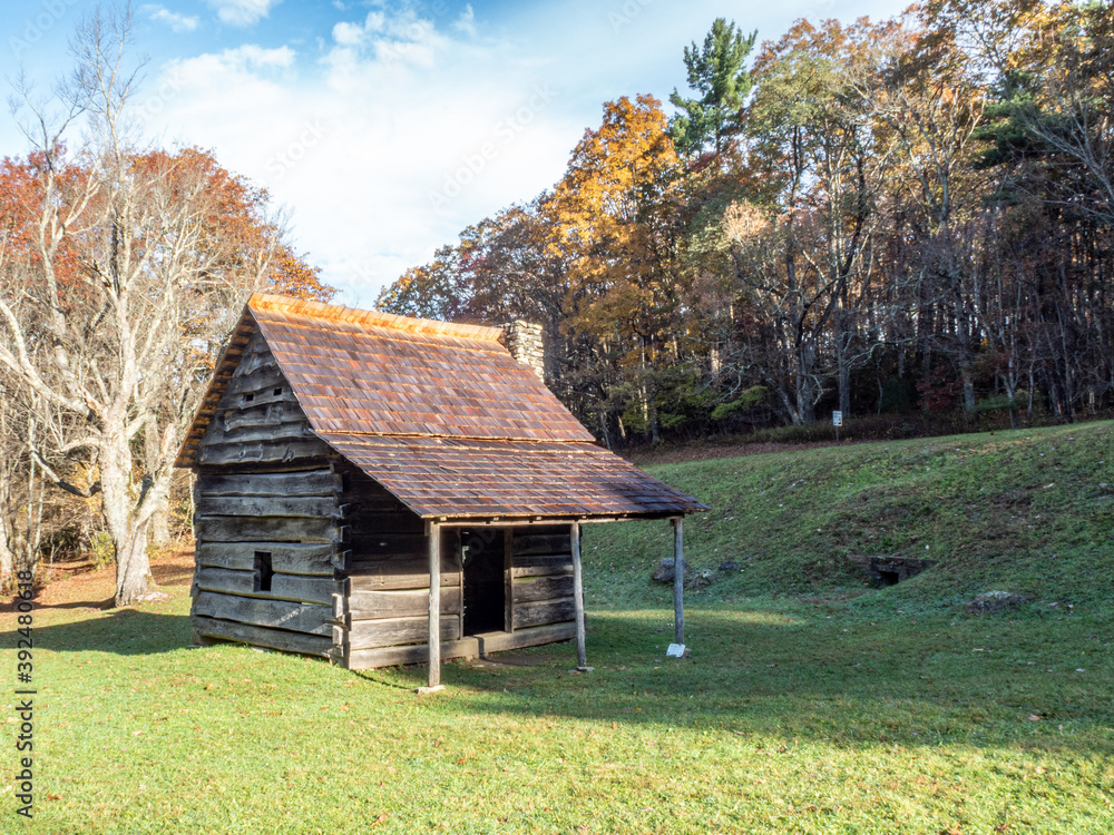 Rustic cabin sits amidst the beautiful autumn foliage and early morning sunlight. Rustic cabin sits amidst the beautiful autumn foliage and early morning sunlight.