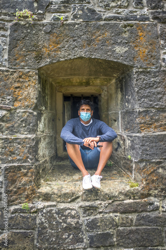 man posing with a blue surgical mask