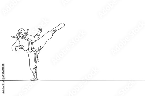 Single continuous line drawing of young Japanese culture ninja warrior on mask costume with attacking kick pose. Martial art fighting samurai concept. Trendy one line draw design vector illustration