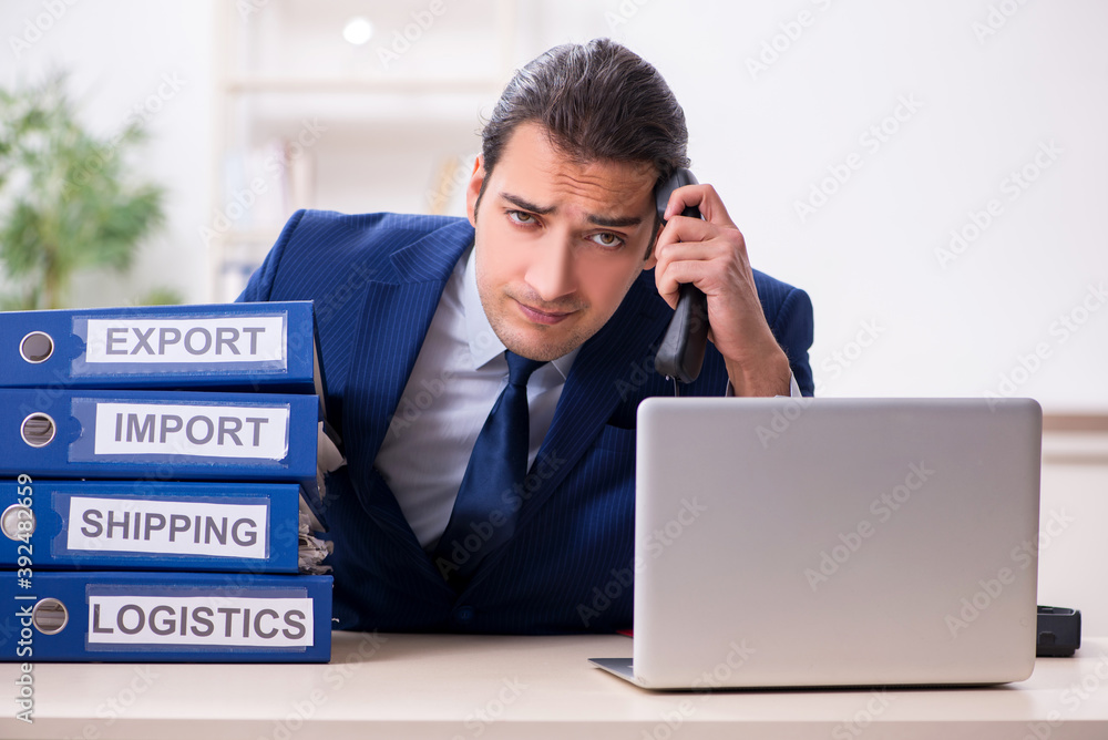 Young male logistics specialist working in the office Young male logistics specialist working in the office