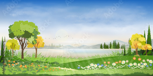 Blue sky with cloud, lake and farmland in countryside on spring,Village with grass land, skyline with sun rays in evening summer.Natural horizontal Concept for spring in morning or summer in evening