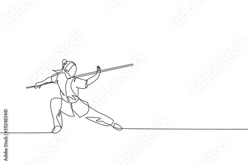 Single continuous line drawing of young woman wushu fighter, kung fu master in uniform train with long staff at dojo center. Fighting contest concept. Trendy one line draw design vector illustration