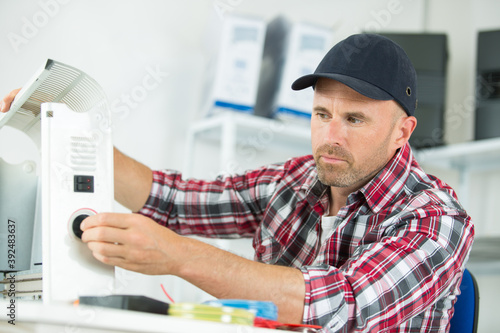 portrait of repairman fixing device