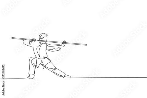 One continuous line drawing of young wushu master man, kung fu warrior in kimono with long staff on training. Martial art sport contest concept. Dynamic single line draw design vector illustration