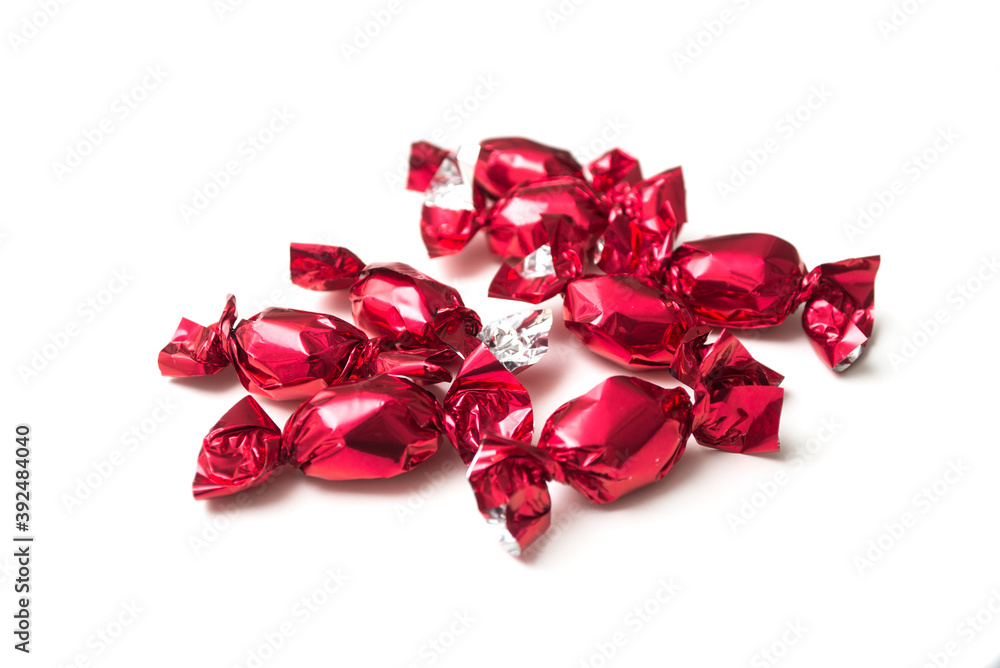 Closeup of chocolate candies in a red paper on white background Closeup of chocolate candies in a red paper on white background