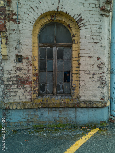 Old window with broken glass of old building photo