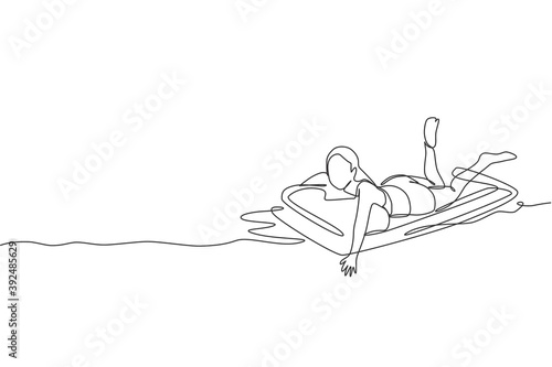 One continuous line drawing of young happy beauty woman relaxing at air mattress in swimming sport center. Summer holidays and vacation concept. Dynamic single line draw design vector illustration