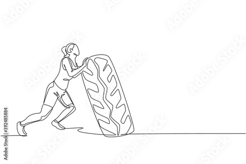 One single line drawing of young energetic woman exercise lift and push big heavy tire in gym fitness center vector illustration. Healthy lifestyle sport concept. Modern continuous line draw design