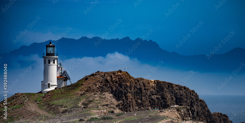 Lighthouse on Anacapa Island, Channel Island National Park with California coast in distance