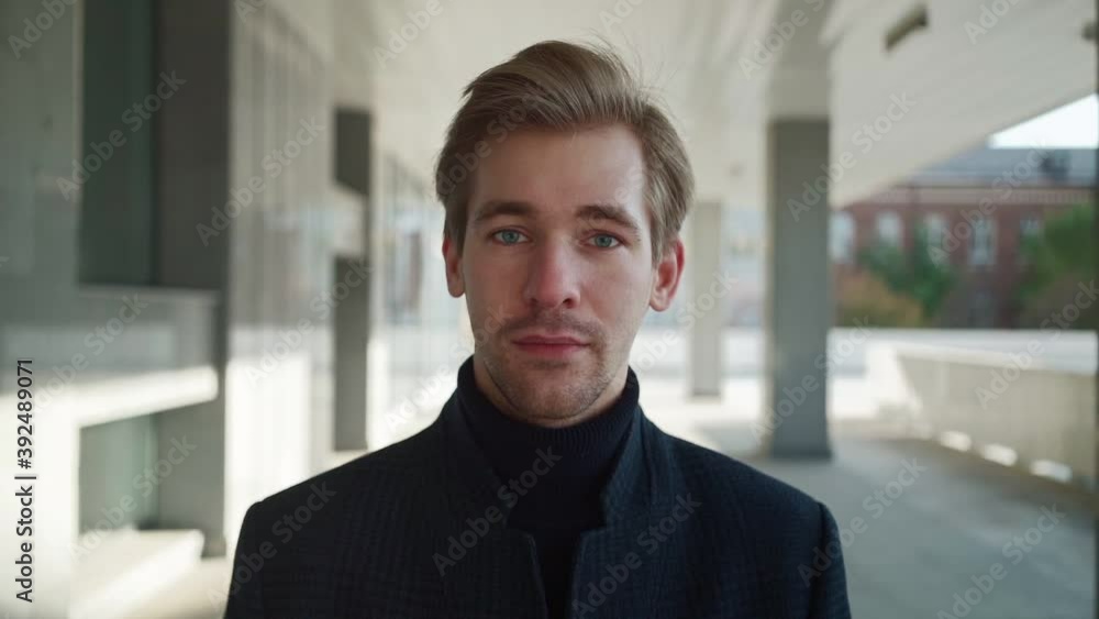 Portrait of a handsome serious man looking at the camera against an urban background. Caucasian young guy. Slow motion. High quality FullHD footage. Portrait of a handsome serious man looking at the camera against an urban background. Caucasian young guy. Slow motion. High quality FullHD footage.