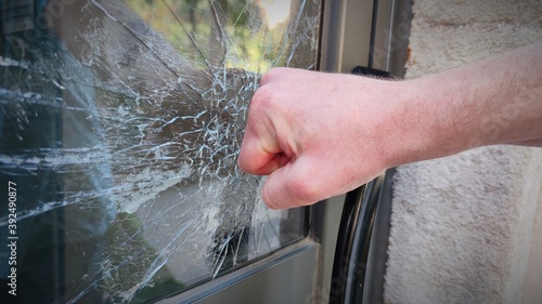 Barcelona, Catalonia, Spain- October 27, 2020:A violent, vandal person breaks and destroys a window with a punch