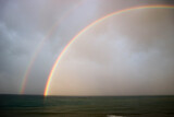 bright beautiful colorful double rainbow over the sea