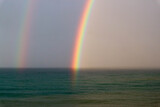 bright beautiful colorful double rainbow over the sea