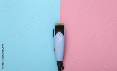 Hair clipper on a pink blue pastel background. Top view