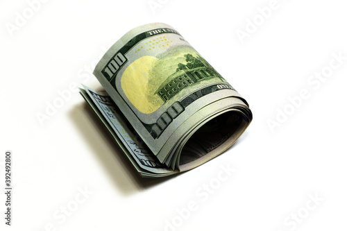 Dollars on a white background. Rolled-up bills.