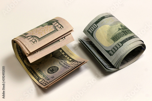 Dollars on a white background. Rolled-up bills.