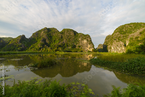Ninh Binh region, Trang An Tam Coc valley tourist attraction, UNESCO World Heritage Site, scenic river crawling through karst mountain ranges in Vietnam, travel destination.