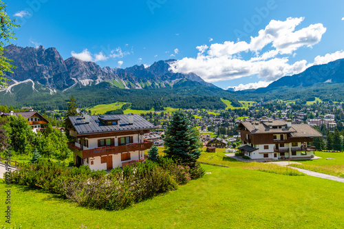 Fototapeta Naklejka Na Ścianę i Meble -  Tourist huts in Cortina d'Ampezzo on a sunny summer day, Dolomites mountains, Italy