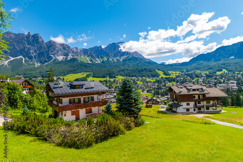 Tourist huts in Cortina d'Ampezzo on a sunny summer day, Dolomites mountains, Italy photo